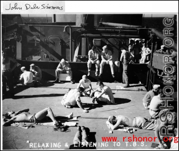 GIs while away the time as they return to the US by ship after war's end, "Relaxing and listening to T. B. S. (tannoy)."  Photo from John Dale Simmons.