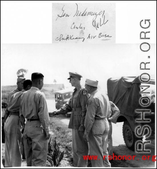 Gen. Wedemeyer shakes hand with soldiers during visit at Zhijiang air base.  In the CBI during WWII.