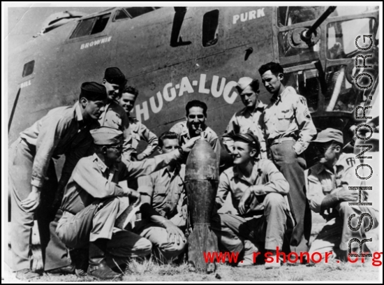 Flyers admire bomb in front of B-24 "Chug-A-Lug" during WWII.  Photo from Emery and Beth Vrana.