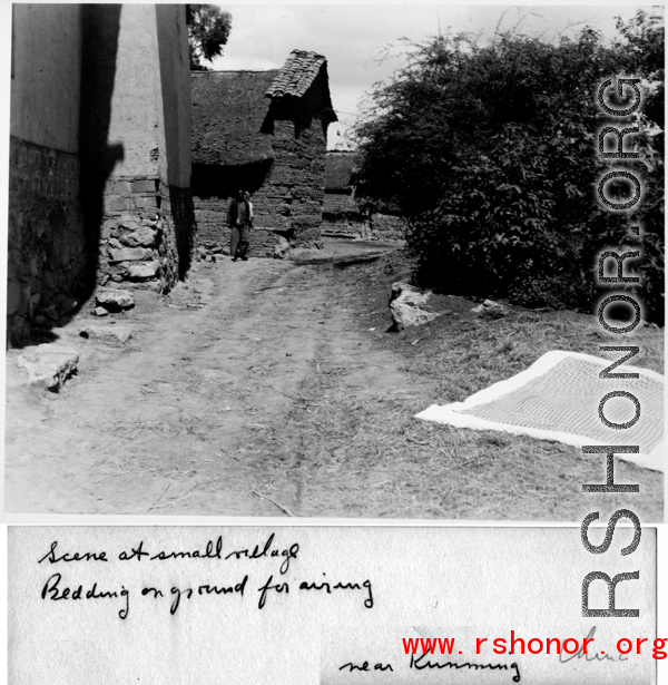 Airing out bedding in small village near Kunming, during WWII.