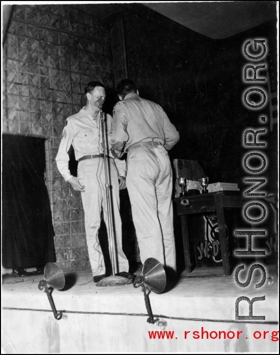 GIs prepare to perform during 54th Air Service Group entertainment, with instruments of the "Jive-o-Lieps" in the background. In the CBI during WWII.