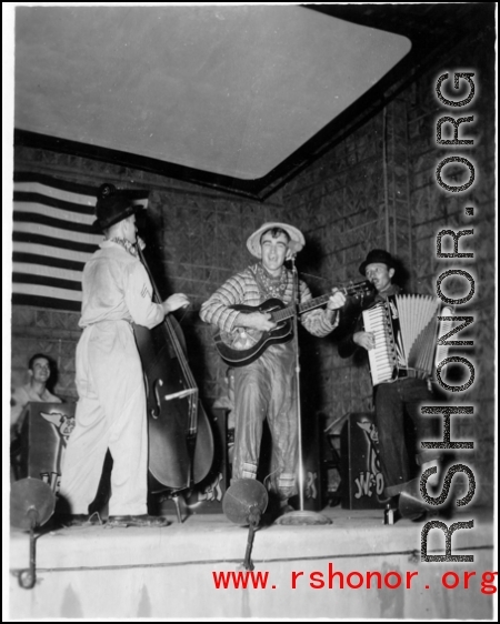 Costumed men perform music, while the "Jive-o-Lieps" of the 54th Air Service Group wait their turn In the CBI during WWII.