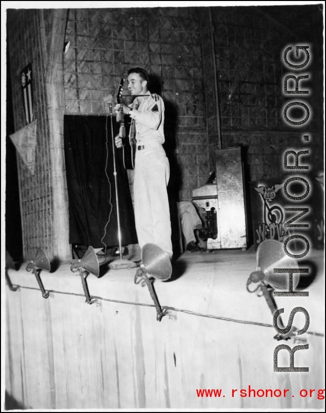 GI plays guitar while the band Jive-o-Lieps waits to music in the CBI during WWII. 54th Air Service Group.