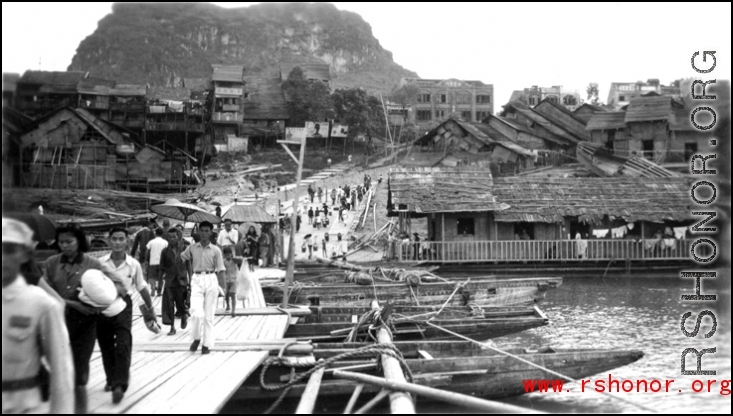 Floating boat-bridge, Floating "boat-bridge, looking towards our side of Luichow, China Sept 1944."  Horse-Saddle mountain (马鞍山) in the background. towards our side of Luichow, China Sept 1944.  From the collection of Frank Bates.