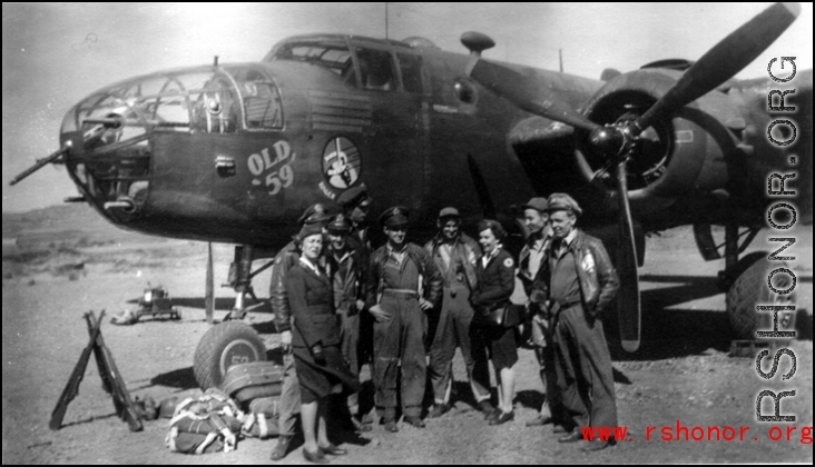 American service men and women pose before "Old 59," March 1944.  From the collection of Frank Bates.