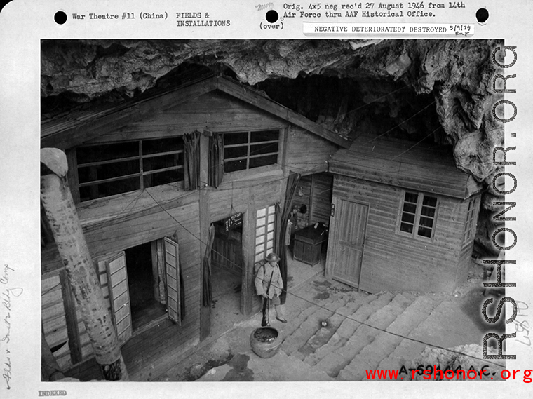 HQ in a cave in Guilin, Guangxi, China, with Chinese guard standing watch.