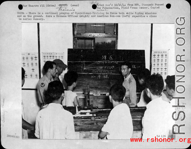 A Chinese officer and American non-com supervise a class in aerial gunnery in the CBI during WWII, as part of Operational Training. 