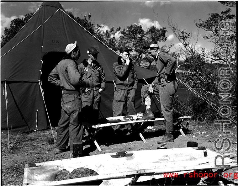 GIs talk and smoke in front of a tent at Qingshuihai lake.