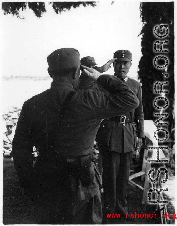 Chinese Lt. General Du Yuming, commander of Nationalist 5th Corps (第五集团军总司令兼昆明防守司令杜聿明) salutes Gen. Wei Lihuang (卫立煌) on stage during rally.