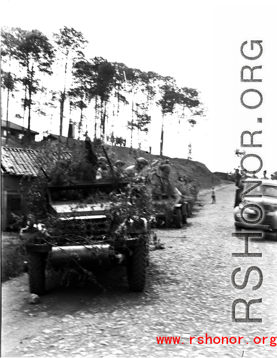 Chinese soldiers with equipment ready and covered in camouflage riding an American M3 Scout Car during exercises in southern China, in Yunnan province.