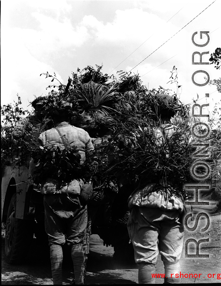 Chinese soldiers with equChinese soldiers with equipment ready and covered in camouflage standing behind American M3 Scout Car during exercises in southern China, in Yunnan province. ipment ready and covered in camouflage during exercises in southern China, in Yunnan province.  Despite the appearance of being on their way to battle, these men are more likely in fact prepared for a demonstration or honor parade. 