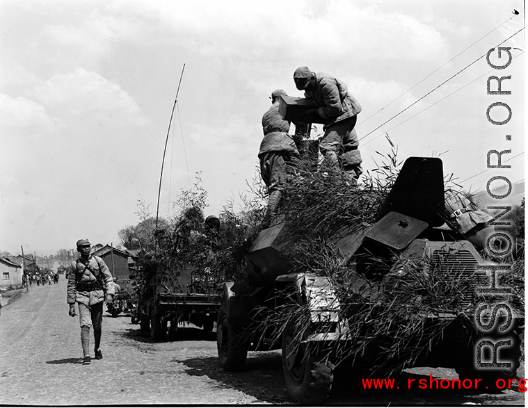 Chinese soldiers making final preparation on armored vehicles, and covered in camouflage during exercises in southern China, in Yunnan province.