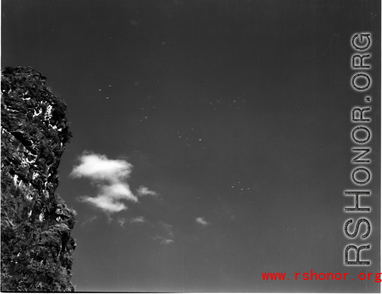 B-25 Mitchell bombers in flight over southern China, with a Karst mountain in the foreground.