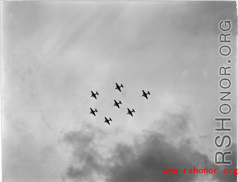 A formation of B-25 Mitchell bombers above in flight in the CBI, in the area of southern China, Indochina, or Burma.