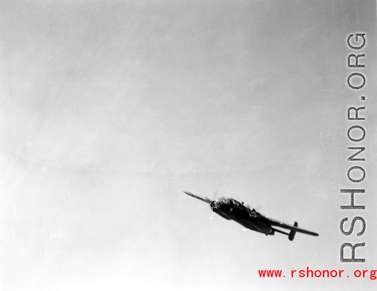 B-25 Mitchell bomber in flight in the CBI, in the area of southern China, Indochina, or Burma.