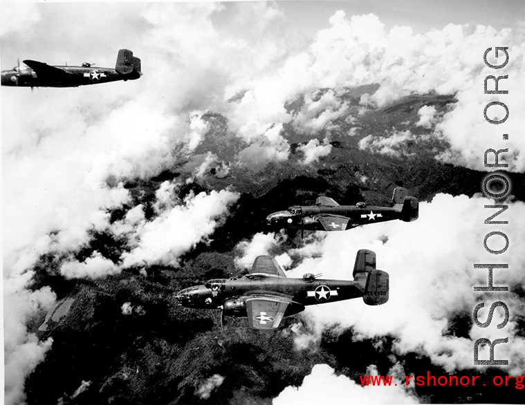 B-25 Mitchell bombers, including tails nos #264650 and #129900, in flight in the CBI, in the area of southern China, Indochina, or Burma.