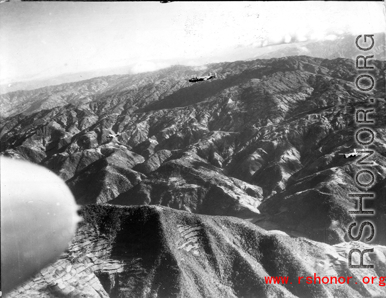 B-25 Mitchell bombers fly in the CBI, probably over SW China or Burma, during WWII.