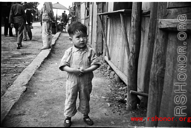 A little boy on the street in Yunnan, China, during WWII.