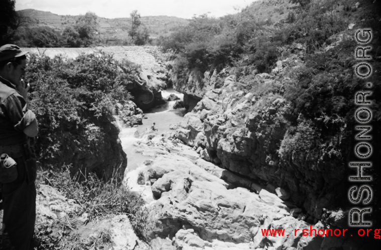 A dam and and falls about 8 miles southeast of the Luliang air base area in Yunnan province, China, where the GIs went to swim and relax. During WWII.