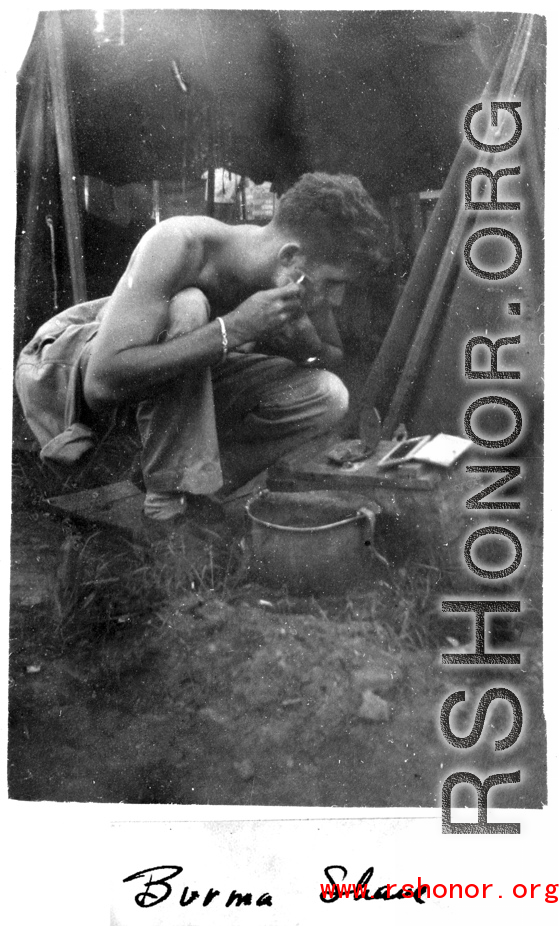 Frank G. Ehle shaving in a tent along the Burma Road during WWII.