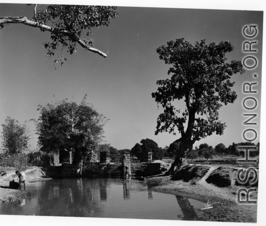 Sluice gates of a water control structure.  Scenes in India witnessed by American GIs during WWII. For many Americans of that era, with their limited experience traveling, the everyday sights and sounds overseas were new, intriguing, and photo worthy.