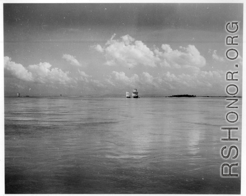 Boats with sails underway in India.  Scenes in India witnessed by American GIs during WWII. For many Americans of that era, with their limited experience traveling, the everyday sights and sounds overseas were new, intriguing, and photo worthy.