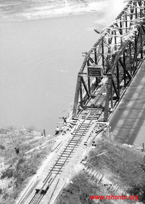 Caught with almost no warning, men on the bridge flee desperately from bombs in the air above them.