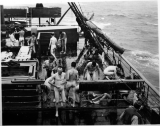 Nude men bathing on transport ship home from CBI to US after WWII.