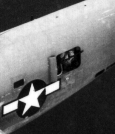 Two waist gunners look up towards photographer's aircraft (undoubtedly another B-24).