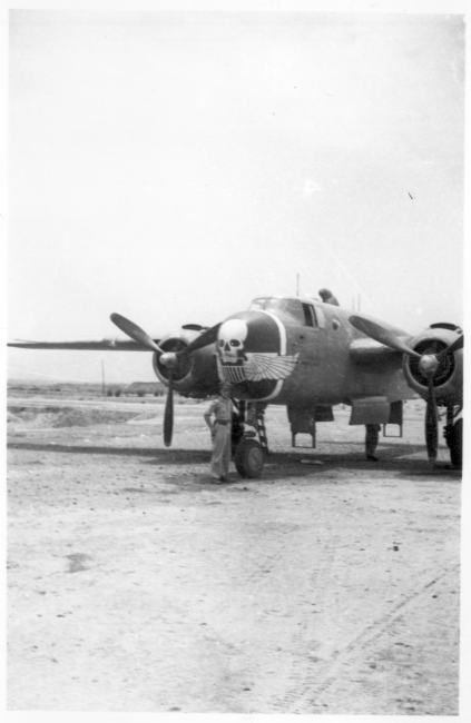 An oversized "Skull & Wings" insignia on plane's side near the nose indicates this parked B-25J Mitchell is assigned to 490th Bomb Squadron, 341st Bomb Group. The 490th had stayed in India, attached to Tenth Air Force, when 341st BG moved from to China in January 1944. With aerial combat finished in Burma, the 490th BS (attached to 312 Fighter Wing) moved in late April 1945 to Hanzhong (Han-chung), southwestern Shaanxi Province, central China. (Additional information courtesy of Tony Strotman.)