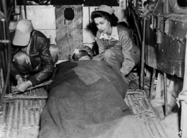 Patient loaded in the waist of a B-24 for evacuation.  Bomb-bay litter support are also used.