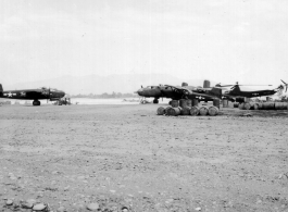 A B-25 on the left.  Spotter plane (probably an L-5) and YR-4B helicopter on the right.