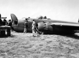 An MP hovers around a crashed B-25 Bomber in the CBI during WWII.