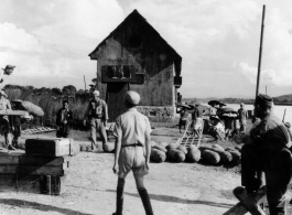 Soldiers of the 14th Air Force, aided by Chinese soldiers and workers, remove bombs from the ammunition dump preparatory to abandoning the Hengyang Airfield.