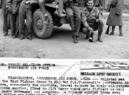 Enlisted men of the 51st Fighter Group in the 14th Air Force, with carbines in hand, travel to work in their all-purpose weapons carrier, fixed to lift heavy bombs onto fighters as well as carry personnel and supplies. A Chinese soldier looks on.  Left to right: Pfc. John H. Carlisle, Pfc. Vincent R. Elliot, Cpl. Ralph E. Manna, T/Sgt. Robert L. Sorenson, Cpl. Reed L. Lehnus, Cpl. Milton Shenk, Sgt. William L. Martenic, M/Sgt. Lawrence E. Linrud, Robert H. Wray, Cpl. Robert C. Mauck, Sgt. Henry E. Kubechek,