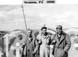 GIs visiting US military graves at Kunming. In the background are markers for the deceased, including for one of George K. Barnes, 74th Fighter Squadron, deceased July 24, 1943.  Photo from Warren C. Smith.