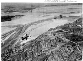 A B-25 bombs 9000-foot Yellow River bridge. June 24, 1944, 1st Bomb Group, Provisional; 2nd Bomb Squadron. Near Kaifeng, Henan, China.