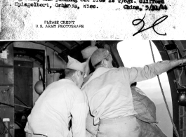 An airdrop of  rice supplies near the Salween River by 14th Air Force crew, from 7500 feet elevation. Twelve 100-lb bags are readied, then pushed out. Kicker on floor is Cpl. Albert A. Baneroft, and on the background Cpl. Milton Chapman, foreground is Pvt. Robert Minnis, and pushing out rice is T/Sgt. Clifford Spiegelbert.