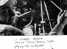 Lt. Robert Meyer in the cockpit of a transport plane (C-46 or C-47 most likely), with sticks on adjustment knobs to act as auto pilot.  332nd Troop Carrier Squadron. In the CBI during WWII.  Photo by W. R. McKenzie.