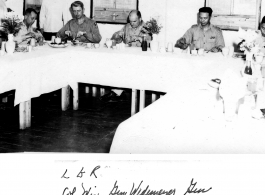 Officers such as Col. Wise, Gen. Wedemeyr, Gen. Al Bennett, and Chinese officers, enjoy a fine meal at Peishiyi upon a visit by Wedemeyer. During WWII.  Photo from M. J. Hollman.