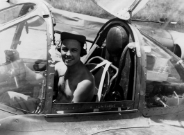 A GI sits in the cockpit of a reconnaissance F-5 (P-38) in the CBI. "Fleming- Lab. Commander."