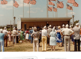 US flags wave at a modern memorial service at Liberty Park, conducted by CBIVA national chaplain, the Rev. Edward Glavin.  Photo from Neil L. Maurer.