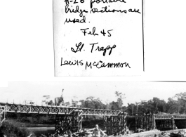 Lt. Trapp standing in front of bridge over Tenai River being built by GIs from H-20 portable bridge sections. February 1945.  Photo provided by Lewis. McCammon.