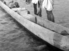 Two men near Misamari, India, show off a tidy string of fish as they stand next to their very long canoe.   Image provided by  "P. Noel."   In the CBI during WWII.