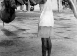 A man shoulders pigs in India.  Local images provided to Ex-CBI Roundup by "P. Noel" showing local people and scenes around Misamari, India.   In the CBI during WWII.