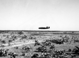 An American B-25D bomber flies at minimum altitude, probably during training / practice of 'low-level attack techniques.' Note the triangular peak just in front of the aircraft. This is probably piled up dirt and sand bags, used as the 'target' to learn and practice, especially for 'skip bombing'.   B-25 pilots of the Tenth Air Force (341st Bomb Group) and Chinese-American Composite Wing (1st Bomb Group) were trained in 'skip bombing' in India during 1943 and 1944.