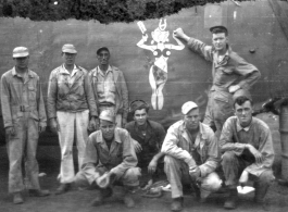 A group of GIs poses before salvaged fuselage of B-24 bomber "Lady Luck II" at Ankang, China, during WWII: "This Is A Group Of 396th Guys I Think At Ankang, China. Kneeling: O'Connor, Wander, Hanson, and Caples. Standing: Euler, Schmidt, Besson, and Tacey."