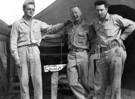 GIs in front of instrument shop tent in Liangshan, China: "Brantl, Wolfe, Hedges Taking A Break To Pose For A Picture In Front Of The Instrument Shop At Liangshan, China. Please Note The Spotless Uniforms In This Photo And All The Other Photos On This Web Site. First Class All The Way." Caption courtesy of Elmer Bukey."