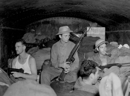 Armed Americans on a train in Assam near Japanese lines. During WWII.