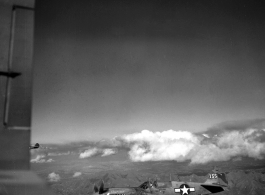 Images of escorting P-40 Warhawks with a painted shark's mouth somewhere over southern China, Indochina, or Burma during WWII, as taken from the tail gunner's window on a B-25 bomber.  Close in is the P-40 nicknamed "Princess," tail number 155.  Who is this man in the cockpit?  This plane is likely of 75th Fighter Squadron, 23rd Fighter Group.